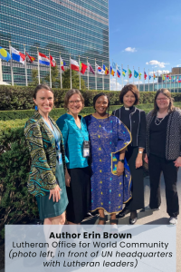 Five women standing in front of the UN headquarters with international flags in the background.