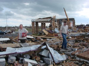 Director Kevin Massey and Associate Director Mike Nevergall stand among what is left of Peace Lutheran Church