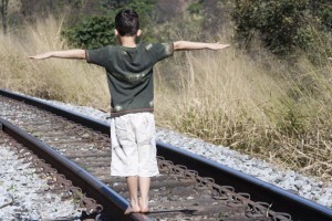 boy on train tracks