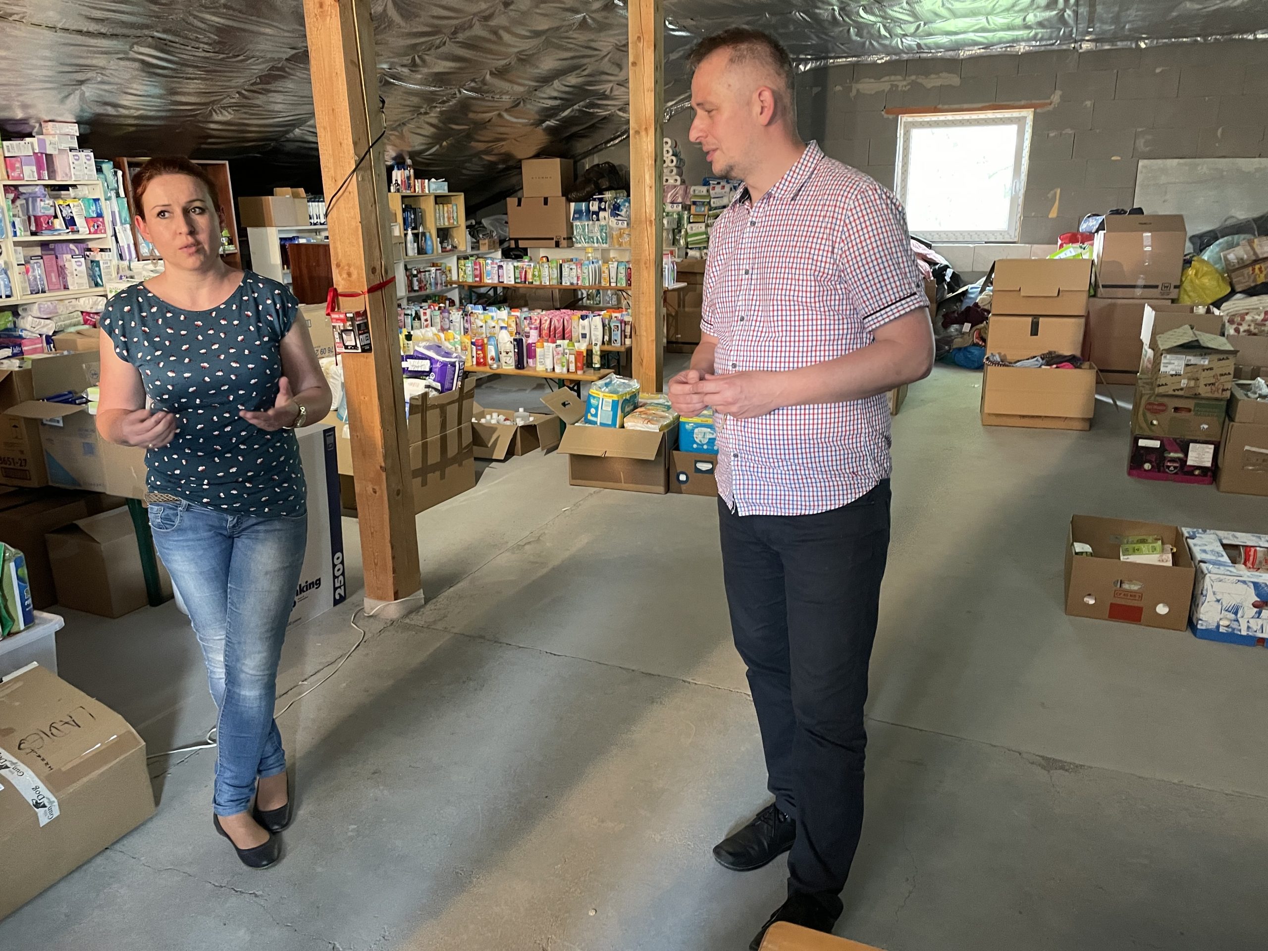 An image of two people, a man and a woman, in a stocked warehouse in Slovakia.