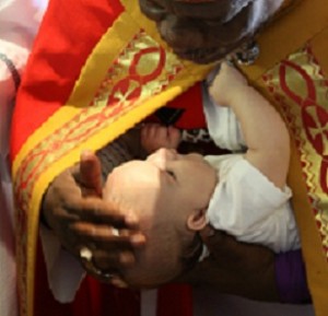 Bishop M. Biyela baptizes Khaya.