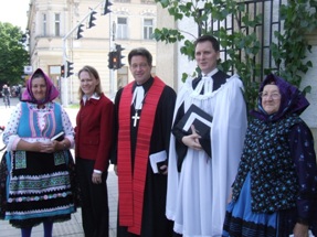 Flanked by Serbian women in traditional dress, the U.S. Ambassador to Serbia Mary Burce Warlick (the daughter of Lutheran missionaries), Arden Haug and Pastor Igor Feldi greet worshipers after the service.