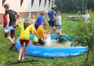 Cooling off with water games at the summer church camp.
