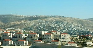 Typical Israeli settlements, one above and one below a Palestinian village.