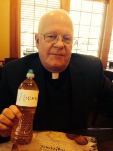 Rev. Eggleston holds a bottle of water drawn from the tap at Salem Lutheran Church in Flint, Mich.
