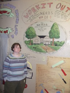 Suzie Harvey in front of the art work inside Camp Victor