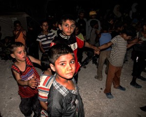 Children from Za'atri camp attend a puppet show that raised awareness against gender-based violence.