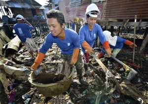 Participants in a cash for work program clean up debris in Tacloban, a city in the Philippines province of Leyte that was hit hard by Typhoon Haiyan in November 2013. The storm was known locally as Yolanda. The ACT Alliance has been active here and in affected communities throughout the region helping survivors to rebuild their homes and recover their livelihoods.