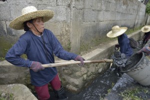 Ida Yabigail, 52, helps to clean up her community following Typhoon Haiyan, removing refuse from blocked drainage ditches as part of a cash for work program sponsored by Lutheran World Relief, a member of the ACT Alliance. Her neighborhood in Ormoc, a city in the Philippines province of Leyte, was hit hard by the typhoon, known locally as Yolanda, in November 2013. LWR and other ACT Alliance members have been providing a variety of forms of assistance to survivors here.