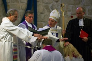 (Left to Right) Rev. Ibrahim Azar, Pastor of the Arabic Speaking congregation of the Lutheran Church of the Redeemer; Rev. Mark Brown, Church Council Chairperson of the English Speaking congregation of the Lutheran Church of the Redeemer; Bishop Munib Younan, Bishop of the ELCJHL; Propst Wolfgang Schmidt, Representative of the Evangelische Kirche Deutschland in Jerusalem bless Rev. Dr. Martin Zimmann and Rev. Dr. Angela Zimmann. © Danae Hudson/ELCJHL