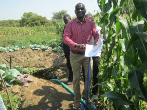 Extension worker Chesterman Kumwenda demonstrates how to use a treadle pump.