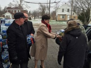 Presiding Bishop Elizabeth Eaton, Rev. jack Eggleston and Rev. Ken Fouty from the Southeast Michigan Synod distribute water at Salem Lutheran Church in Flint, Mich.